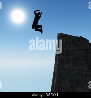 Silhouette of the jumping man from a rock Stock Photo