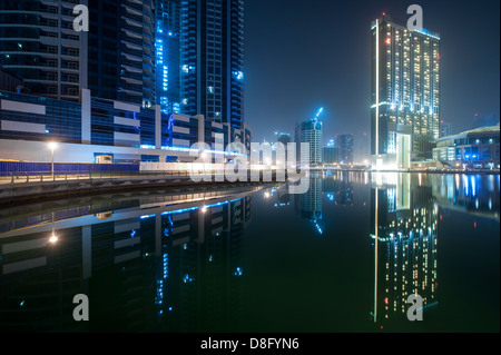 Skyscrapers in Dubai Marina at night with reflections, New Dubai, UAE