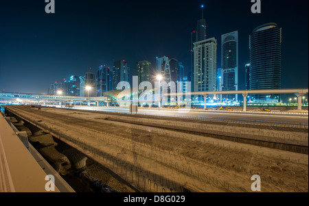 View construction site Al Soufouh Tram Systems in Marina skyscrapers Jumeirah Lakes Towers (JLT) night New Dubai UAE Stock Photo