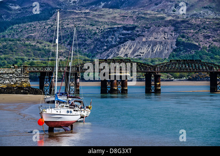 Barmouth Bridge and ships during low tide Stock Photo