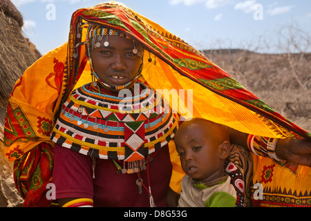 Rendille girl in traditional dress with child.Kenya Stock Photo