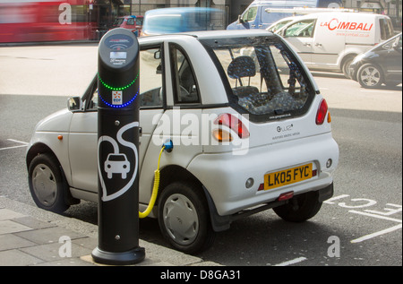 A G Wizz electric car at a pavement recharging station in London. Stock Photo