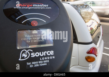 A G Wizz electric car at a pavement recharging station in London. Stock Photo
