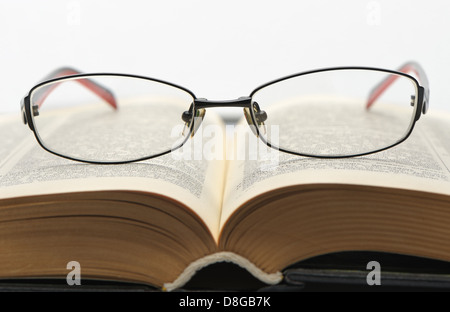Eyeglasses on the old thick book Stock Photo