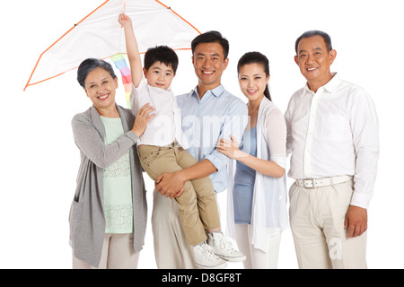 Whole family holding kite Stock Photo