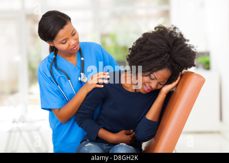 african female medical worker comforting a sick patient in hospital Stock Photo