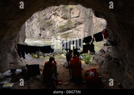 Kayakers camping in a cave on a trip down Idaho's Bruneau River. Stock Photo