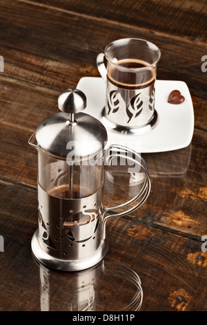 Elegant Coffee Cup Served Along With Filter Against Heavy Polished Wood Table Stock Photo