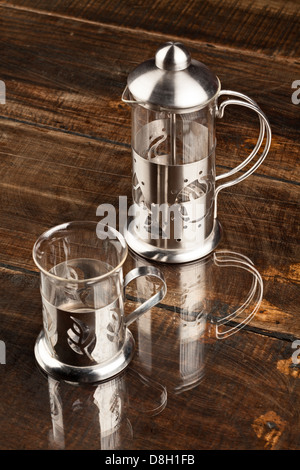 Elegant Coffee Cup Served Along With Filter Against Heavy Polished Wood Table Stock Photo