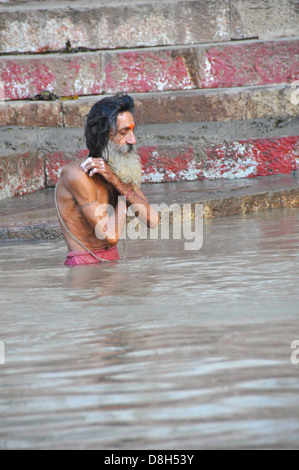 Holy man bathing in the Ganges river in Varanasi, Uttar Pradesh, India Stock Photo