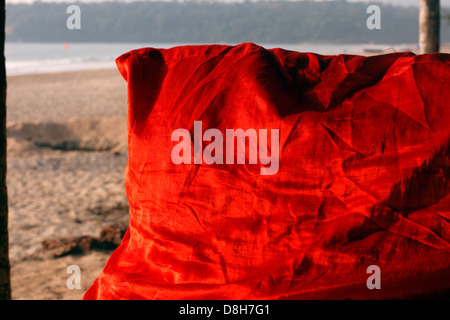 Red silk cushion at a beach side bar, Agonda, South Goa, India Stock Photo