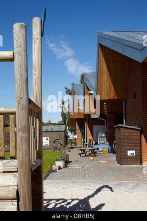 The Winchcombe School, Newbury, United Kingdom. Architect: Architype Limited, 2012. Playground and school facade in perspective. Stock Photo
