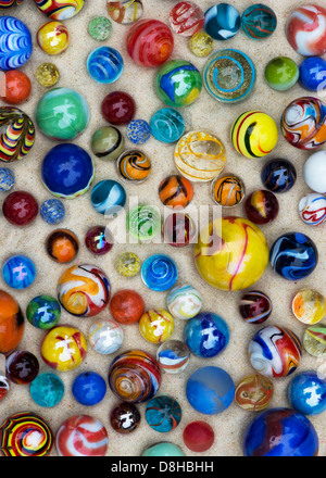 Colourful marbles on sand pattern Stock Photo