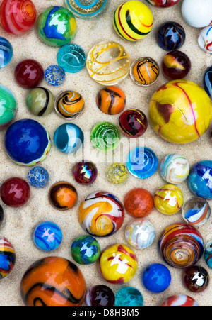 Colourful marbles on sand pattern Stock Photo