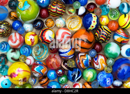 Colourful marbles on sand pattern Stock Photo
