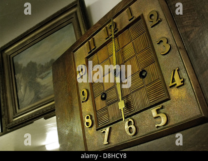Old Art Deco style clock with hands in brown, England, UK Stock Photo