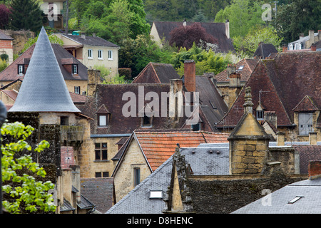Jumble of tile rooftops emerges from medieval sandstone houses in charming Sarlat, Dordogne region of France Stock Photo