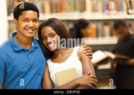 happy african college couple in library Stock Photo