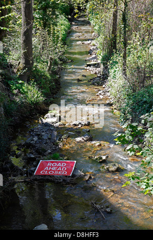Road ahead closed sign in stream Stock Photo