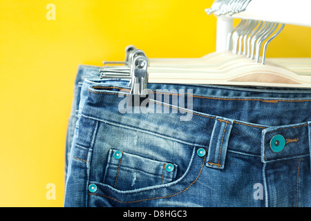 Row of hanged blue jeans in a shop Stock Photo