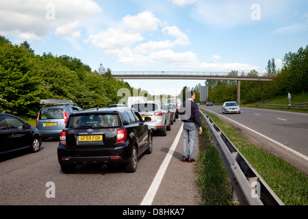 People on the road during a traffic jam due to an accident on the A20 dual carriageway road, Kent UK