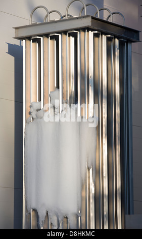 Isolated industrial size cooling system ' s condenser at a dairy and ice packed to it Stock Photo