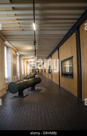 Paris, France. An ancient cannon in a hallway in the Museum of the Army at the Invalides Palace. Stock Photo