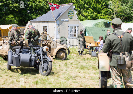 Overlord, D-Day re-enactment at Denmead 2013. German soldiers relaxing, standing around and talking. Stock Photo