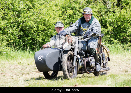 Overlord, D-Day re-enactment at Denmead 2013. Two German soldiers riding a BMW motorcycle and sidecar Stock Photo