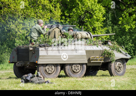 Overlord, D-Day re-enactment at Denmead 2013. American M8 Greyhound Armoured car advancing on German lines. Stock Photo