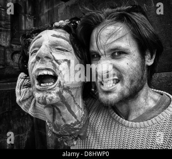 Festival puppet entertainer with a severed head , August High street, Edinburgh Old Town, Lothian, Scotland UK Stock Photo