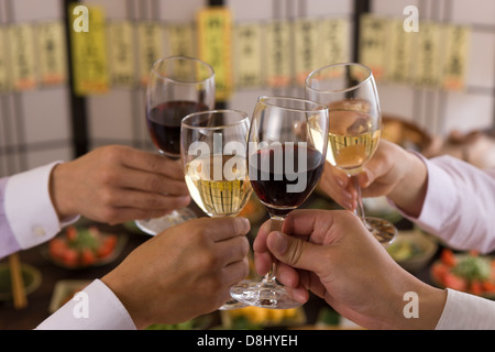 Four People Toasting with Wine at Izakaya Stock Photo