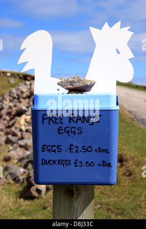 Free range eggs and duck eggs for sale at the entrance to a farm in Sutherland in the highlands of Scotland Stock Photo