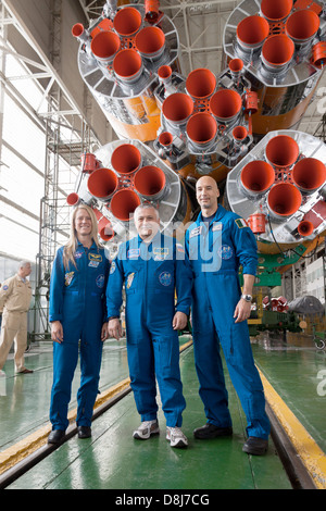 Expedition 36/37 Flight Engineer Karen Nyberg of NASA (left), Soyuz Commander Fyodor Yurchikhin (center) and Flight Engineer Luca Parmitano of the European Space Agency (right) pose for pictures in front of their Soyuz TMA-09M spacecraft in advance of their launch May 24, 2013 at the Baikonur Cosmodrome in Kazakhstan. Nyberg , Yurchikhin and Parmitano are preparing to begin a 5 month mission to the International Space Station. Stock Photo