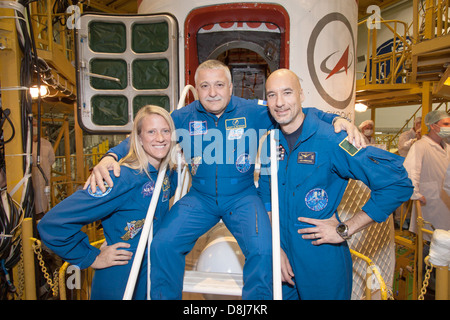 Expedition 36/37 Flight Engineer Karen Nyberg of NASA (left), Soyuz Commander Fyodor Yurchikhin (center) and Flight Engineer Luca Parmitano of the European Space Agency (right) pose for pictures in front of their Soyuz TMA-09M spacecraft in advance of their launch May 24, 2013 at the Baikonur Cosmodrome in Kazakhstan. Nyberg,  Yurchikhin and Parmitano are preparing to begin a 5 month mission to the International Space Station. Stock Photo