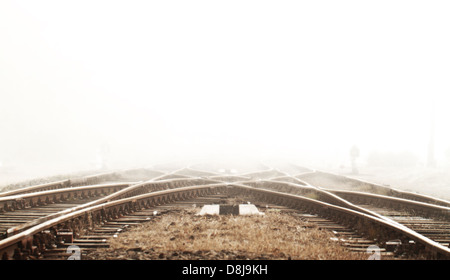 Railway in fog on station Stock Photo