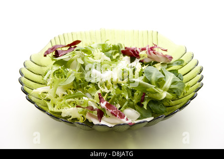 Mixing salad in the glass bowl Stock Photo