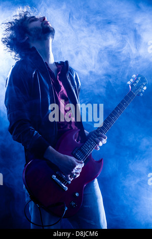 Young Man Playing Electric Guitar Stock Photo