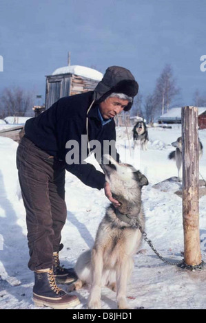 Native American resident man with sled dog. Stock Photo