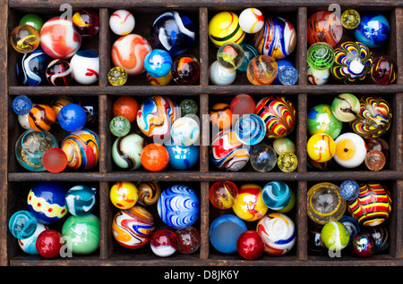 Colourful marbles in a wooden tray pattern Stock Photo