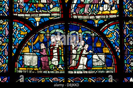 Medieval (C13th) stained glass in the Trinity Chapel of Canterbury Cathedral, depicting two views of worshippers at the shrine of St Thomas Becket. Stock Photo