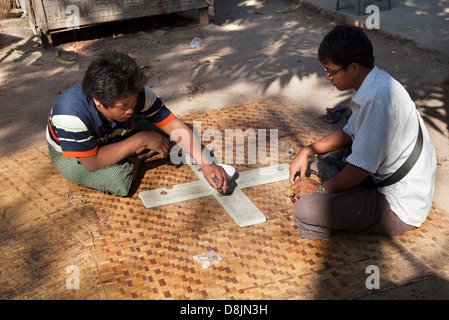 Unusual board game being played in the street, Mandalay Myanmar Stock Photo