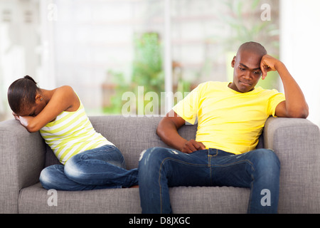 young african couple having conflict sitting on the sofa Stock Photo