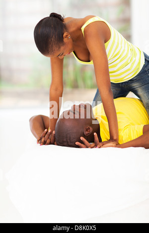 playful young african couple in bed Stock Photo