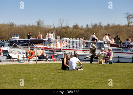 People enjoying the sunshine on May Bank Holiday weekend, Maltster Broad, Norfolk Broads UK Stock Photo