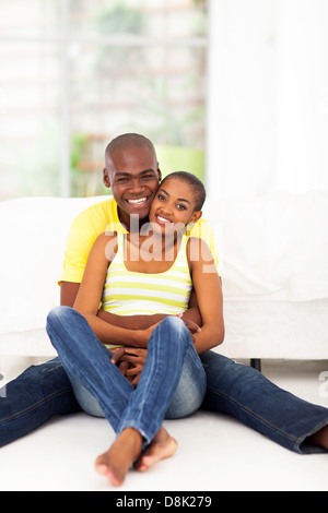 portrait of young attractive african couple sitting on the bedroom floor Stock Photo