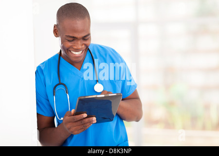 young handsome African American medical worker using tablet computer in hospital Stock Photo