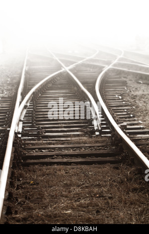 Railway in fog on station Stock Photo