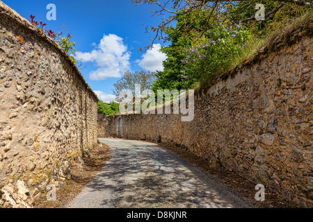 Narrow road between stone walls in a small French town Stock Photo