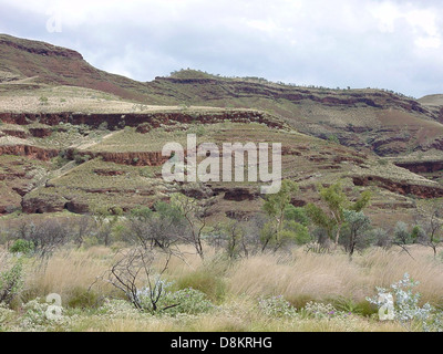 The rock strata along Munjina Wittenoom Road are showcased, displaying various layers of rock formations. These geological features provide insight into the Earth's history and natural processes. Stock Photo